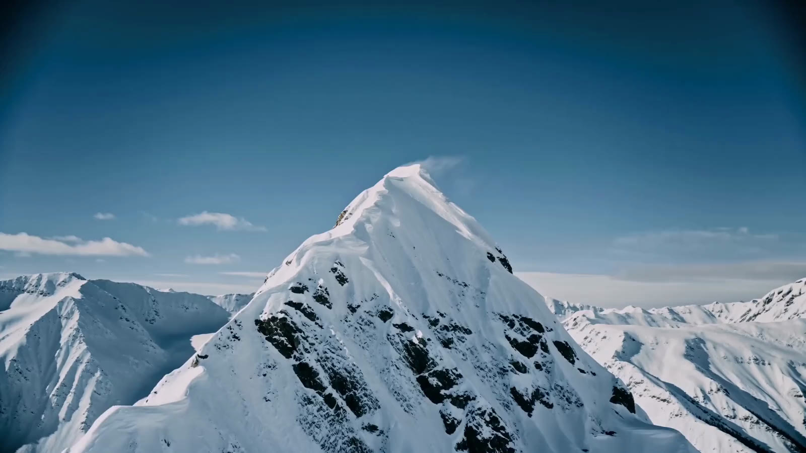 Snow-covered mountain ridge under a clear sky