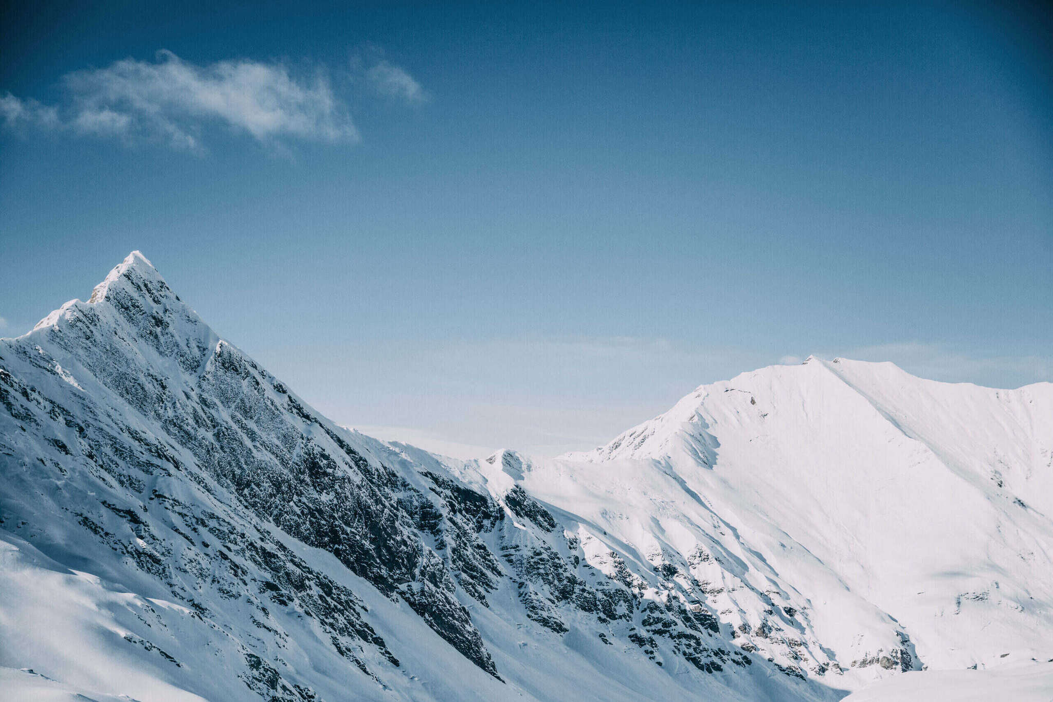 Snow-covered mountain ridge under a clear sky