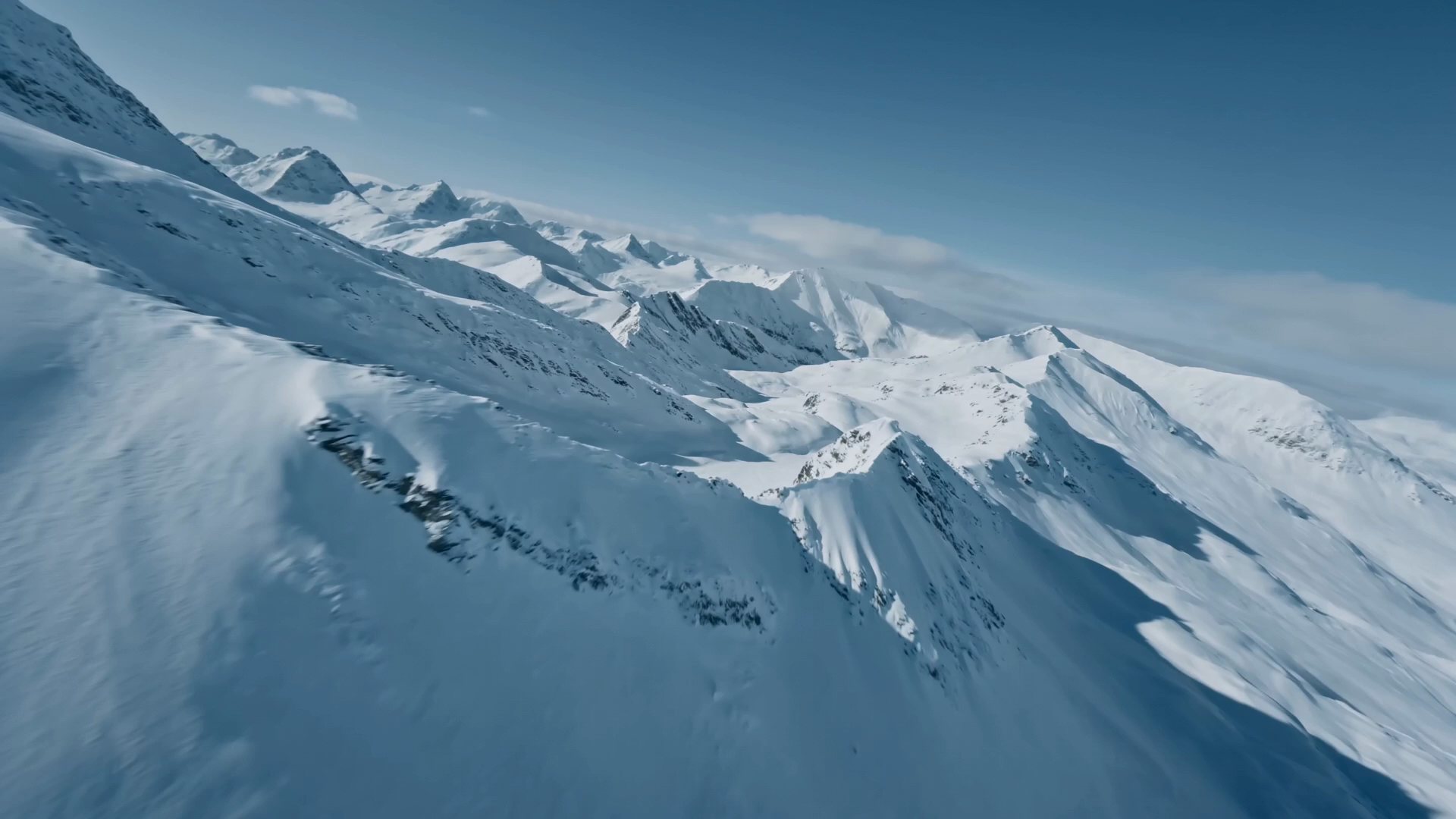 Forward flight over a snow-covered mountain ridge